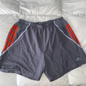 Grey and orange Adidas running shorts.